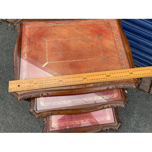 86 - Three vintage nesting tables, carved edgings with cabriole legs, glass on leather tops