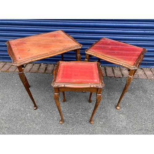 86 - Three vintage nesting tables, carved edgings with cabriole legs, glass on leather tops