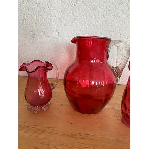 151 - Collection of Cranberry Glass Jugs