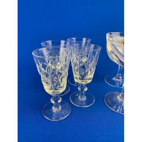 147 - Four Crystal d'Arques Coupe Glasses and Four Cut Wine Glasses