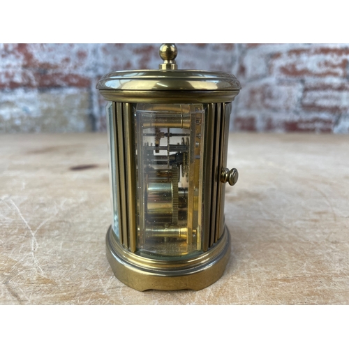 39 - Matthew Norman London, Miniature Swiss Made Oval Brass Carriage Clock. 8 Day Movement. Missing Key.