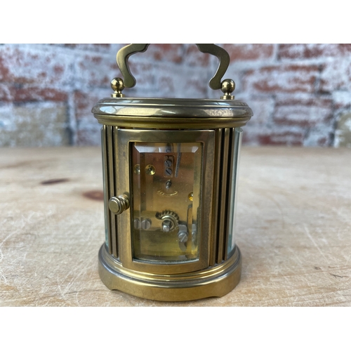 39 - Matthew Norman London, Miniature Swiss Made Oval Brass Carriage Clock. 8 Day Movement. Missing Key.