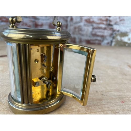 39 - Matthew Norman London, Miniature Swiss Made Oval Brass Carriage Clock. 8 Day Movement. Missing Key.