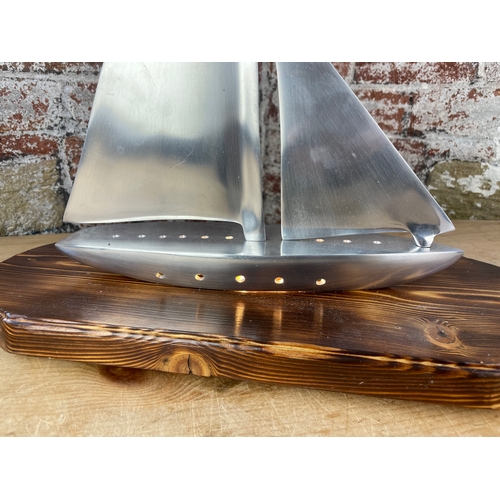 345 - Machined Aluminium Sailing Boat Lamp On Carved Wooden Plinth.