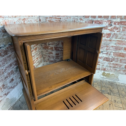 438 - Ercol Golden Dawn TV Cabinet on wheels with retractable doors