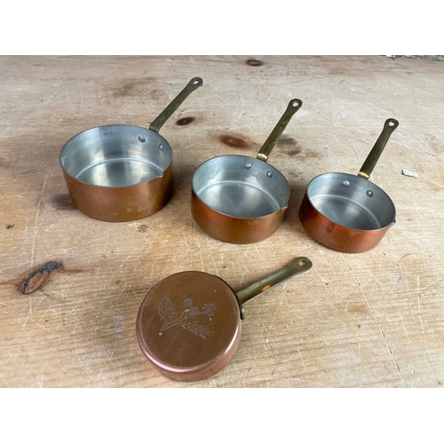 322 - Four Vintage Copper Measuring Pans.