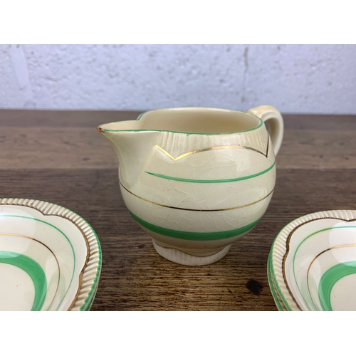 250 - 7 Pieces of Clarice Cliff Green and Gold - Jug a/f