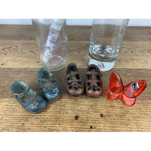 295 - Decorative Children's Shoes, Racing Television Decanter, Love Potion and Glass Butterfly