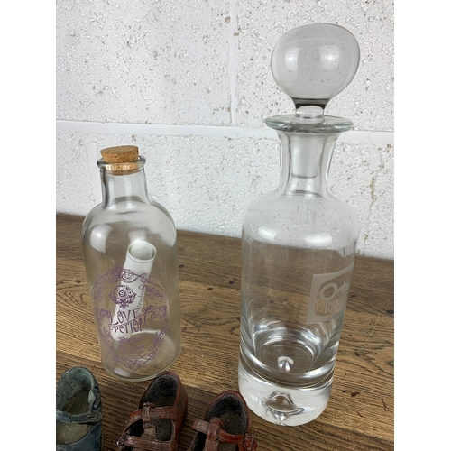 295 - Decorative Children's Shoes, Racing Television Decanter, Love Potion and Glass Butterfly