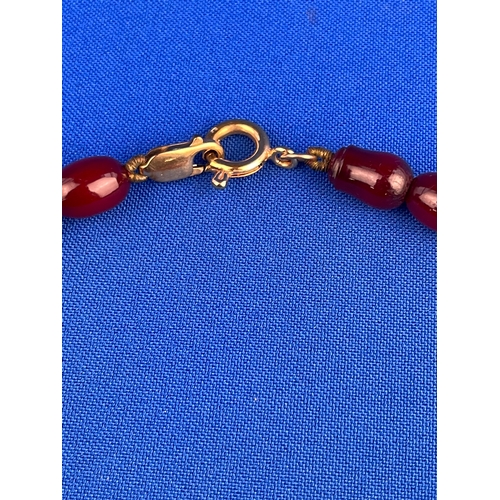 11 - Graduated Cherry Amber Bakelite Necklace With 9ct Gold Clasps. Weighing 44.33g Gross On Knotted Stri... 