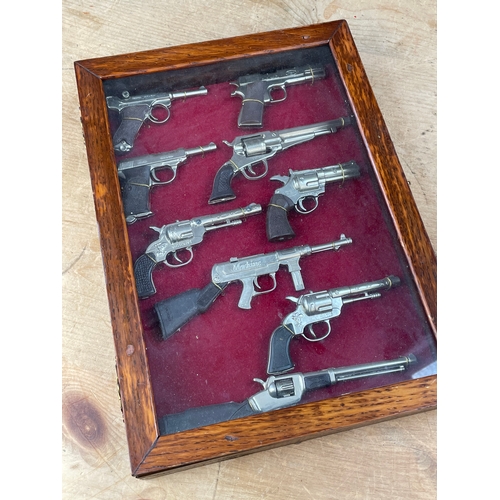 195 - Display Case Of Miniature Replica Guns