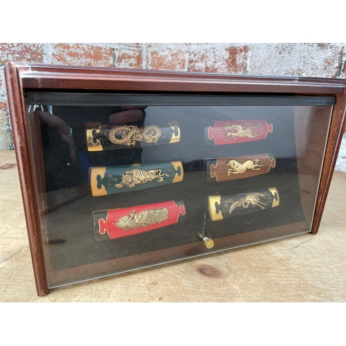 196 - Display Case Of Franklin Mint Folding Chinese Knives