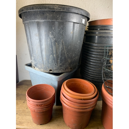 310 - Huge Collection of Plastic Plant Pots, Tubs and Hanging Baskets