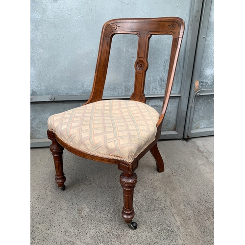 435 - Antique Chair with Castors to the Front Legs and Carving