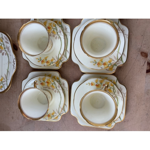 381 - A.B.J. Grafton Bone China Tea Service In Wistaria Pattern. Some Cups A/F