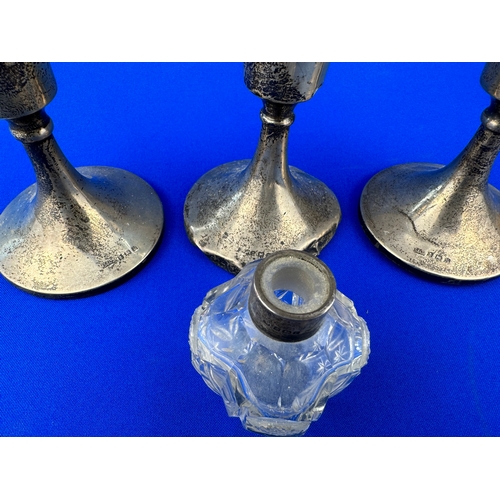 7 - Three Scrap Silver Candle Holders & Silver Topped Cut Glass Scent Botlle missing stopper.