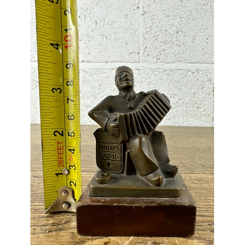 135 - Philips Radio Seated Accordion Player in Brass