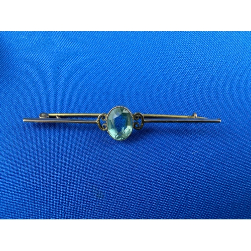 15 - 9ct Rose Gold Bar Brooch set with Blue Stone 3.12g gross.