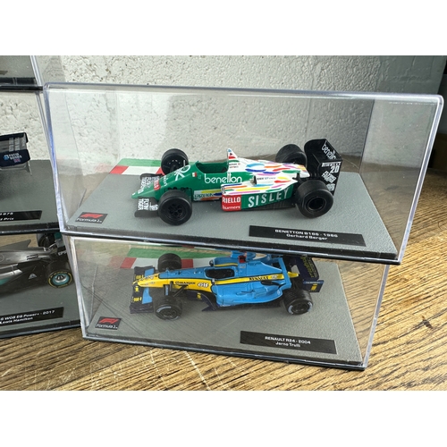 211 - 10 Panini 1:43 Scale Formula 1 Cars From Different Decades  - Lot 8 of 10