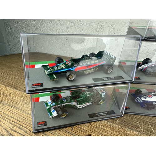 211 - 10 Panini 1:43 Scale Formula 1 Cars From Different Decades  - Lot 8 of 10