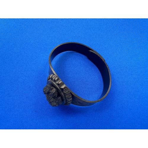 4 - A Victorian Vulcanite Bangle with Oval Floral Panel...