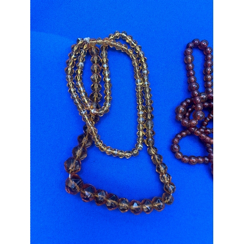 9 - 2 Strings of Amber Beads. Length 36” and 22”. Gross Weight 44.7g....