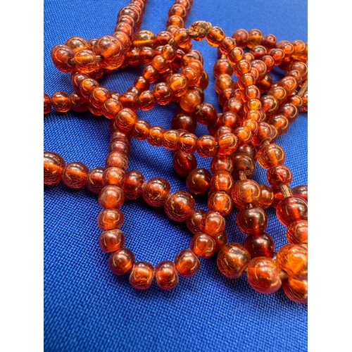 9 - 2 Strings of Amber Beads. Length 36” and 22”. Gross Weight 44.7g....