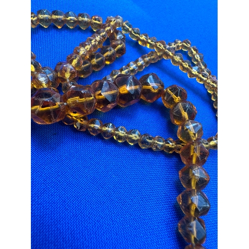 9 - 2 Strings of Amber Beads. Length 36” and 22”. Gross Weight 44.7g....