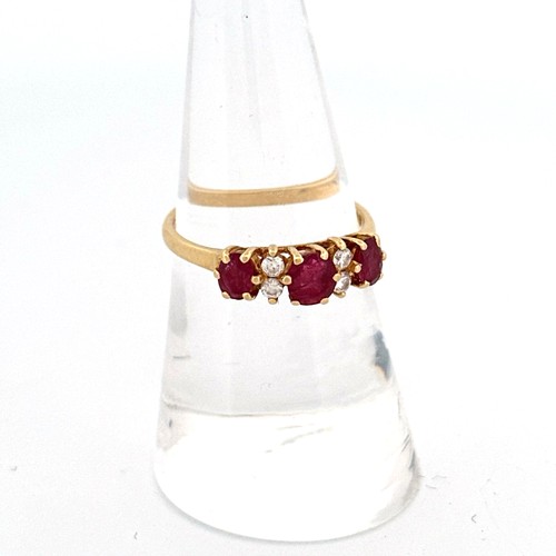 53 - 18ct Gold, Ruby & Diamond Ring - Three Oval Rubies, centre 4.9x4.0mm, outer stones 4.5x3.0mm. Four D... 