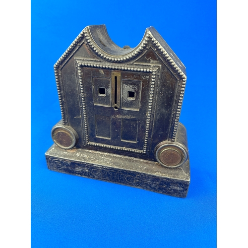 191 - Heavy Cast Iron Money Box with Coins affixed