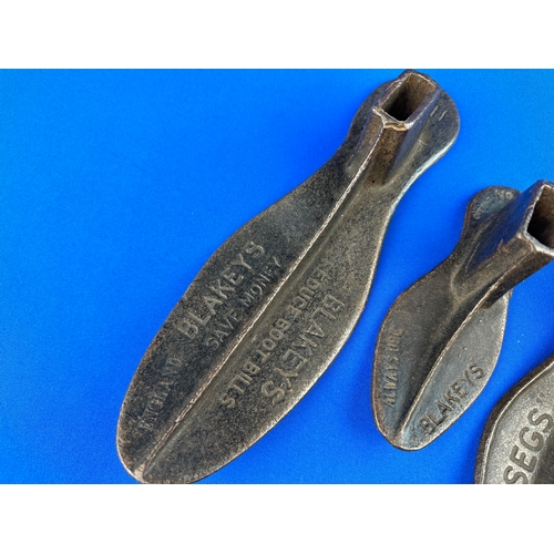 384 - Four Cast Iron Shoe Lasts with Advertising