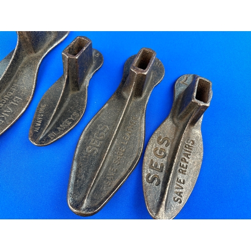 384 - Four Cast Iron Shoe Lasts with Advertising