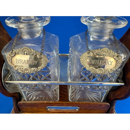 328 - Vintage Oak Tantalus with Key - Working. Two Decanters with Hallmarked Silver Labels