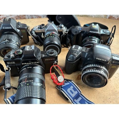 749 - Seven 35mm Film SLR Cameras inc. Minolta, Pentax, Canon, Olympus and Praktica