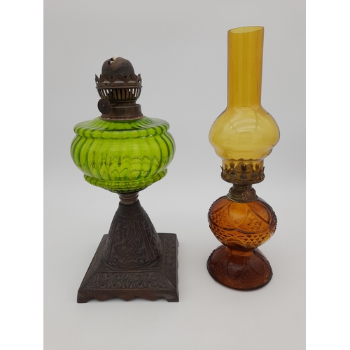 940 - Two Coloured Glass Oil Lamps - one missing chimney