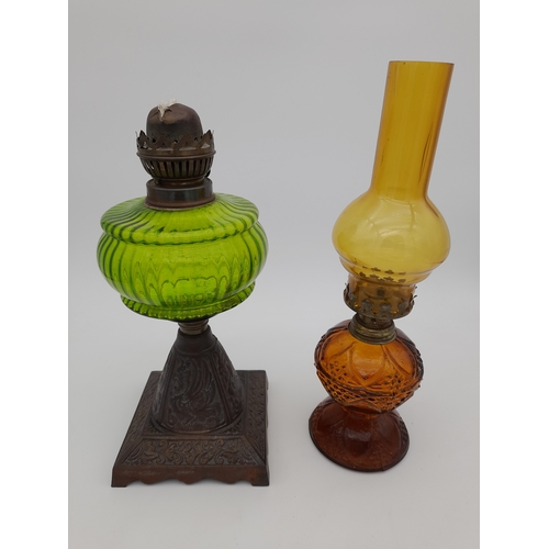 940 - Two Coloured Glass Oil Lamps - one missing chimney