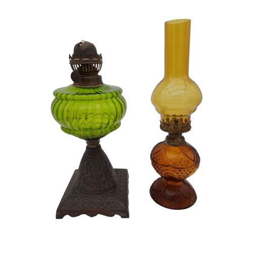 940 - Two Coloured Glass Oil Lamps - one missing chimney