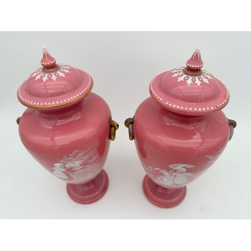 729 - Pair of Victorian Pink Glass Urns & Covers with Mary Gregory Style Enamel Painting - one a/f