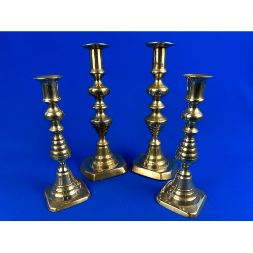 445 - Four Pairs of Brass Candle Sticks in Vrious Sizes.