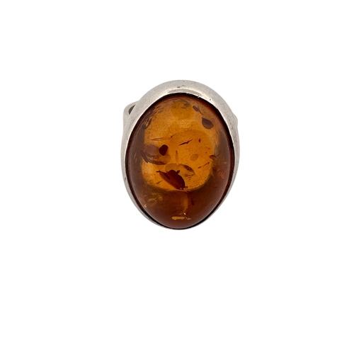 140 - Silver Ring Set with a Large Amber Cabochon. Stamped 925, Size O, 9.5g