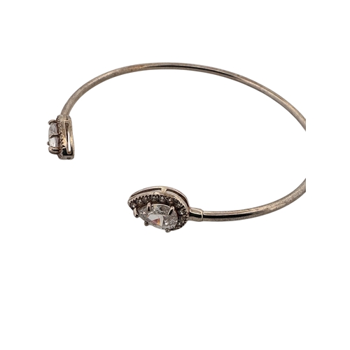 144 - Silver Bangle with CZ Terminals. Stamped 925, 5.6g