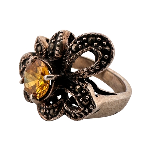 115 - Silver and Marcasite Flower Ring with Yellow Stone. Stamped 925. Size K. 7.4g
