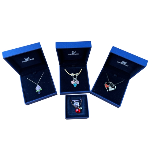 203 - Three Items of Disney Swarovski Pendants alondside Two Other Swarovski Pendants