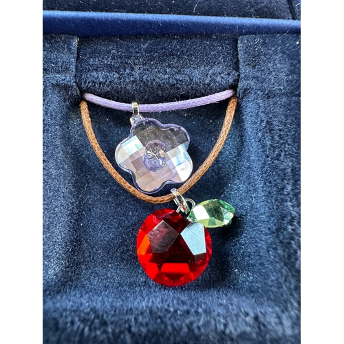 203 - Three Items of Disney Swarovski Pendants alondside Two Other Swarovski Pendants