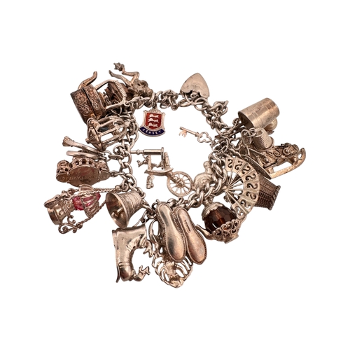 65 - Silver Charm Bracelet with approximately 26 charms. 100g