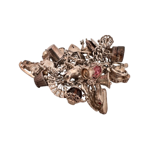 65 - Silver Charm Bracelet with approximately 26 charms. 100g