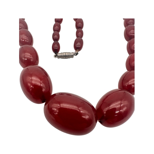 3 - Graduated Cherry Amber Bakelite Beads. 42.9g.  20.5