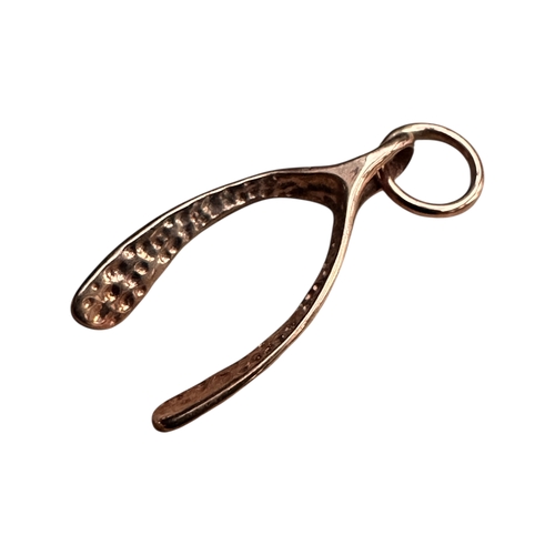 25 - Nine Carat Rose Gold Wishbone Charm. 0.57g...