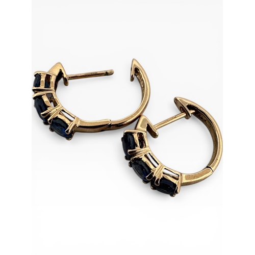 48 - Nine Carat Gold Earrings set with Blue Stones. 2.11g...