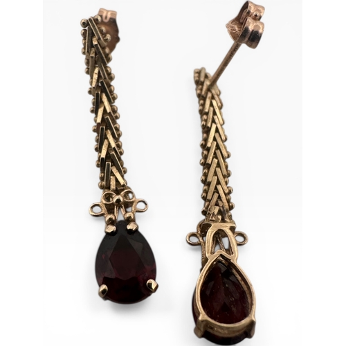 57 - Pair of Nine Carat Gold Earrings with Garnet Droppers, marked 10k Mexico. 1.95g...
